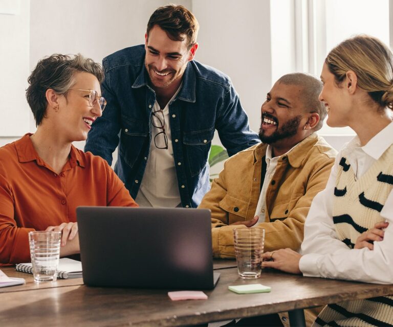 Image of people looking at a laptop